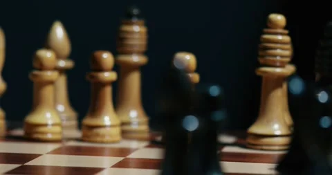 Queen move close up view of the hand of a man playing chess Stock Footage 131134897