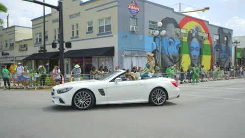 Queen of the St Patricks Day Parade riding in a Mercedes convertible car Stock Footage 267689463
