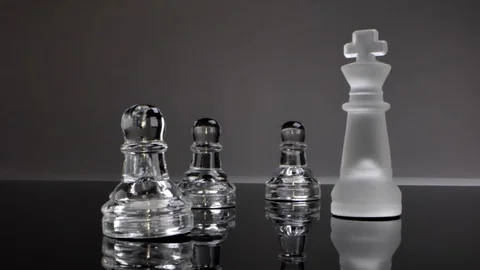 The queen stands opposite her subordinate pawns, power over the minority, Video stock 126558454