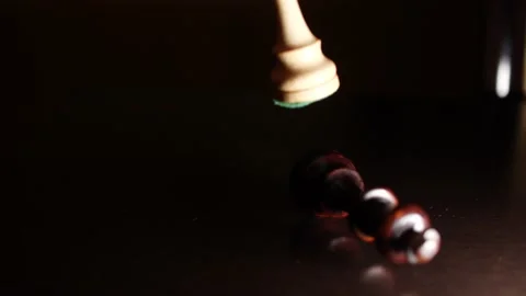 Queen takes king in chess game close up in the dark with light Stock Footage 170286195