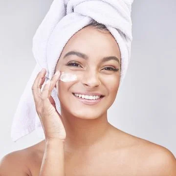 Queens skin for every class. Studio shot of a beautiful young woman applying Stock Photos