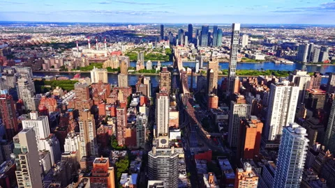 Queensboro bridge spans East river toward Manhattan skyline Stock Footage 341032234