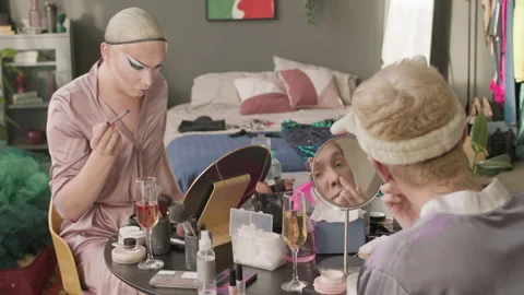 Queer Men Applying Make Up in Cluttered Apartment Video stock 252643159