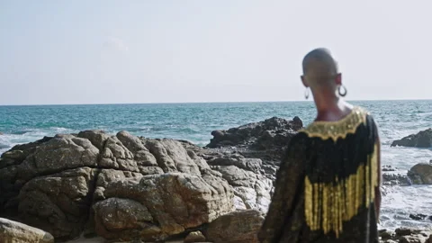 Queer multiracial model poses at scenic seaside location back view. Non-binary Stock Footage 244415657