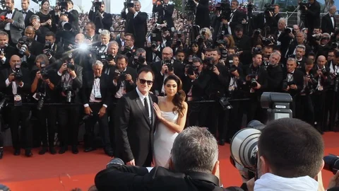 Quentin Tarantino and Daniela Pick posing for the paparazzi on the red Stock Footage 108616932
