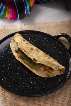 Quesadilla de Comal con queso y Nopales. Typical Mexican quesadilla made on a Stock Photos