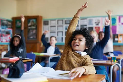Question, hands up and children in classroom with answer for lesson, learning 스톡 사진