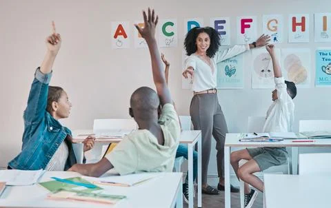 Question, learning and education at school with kids hands raised to answer Stock Photos