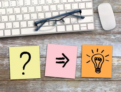 Question mark and light bulb write on colorful sticky note on wood table back Stock Photos