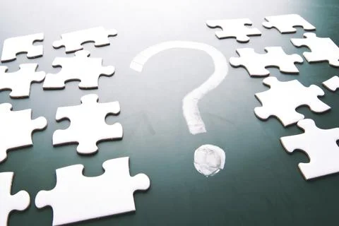 Question mark and puzzle pieces on blackboard Stock Photos