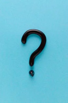 Question mark from black toothpaste on blue background Stock Photos
