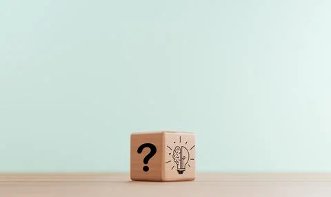 Question mark on dark side wooden block and lightbulb on bright for smart t.. Stock Photos