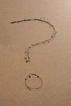 A question mark drawn on the sand of a beach Stock Photos