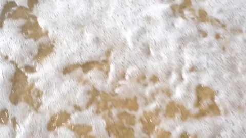 Question mark drawn on sand next to sea wave, top view. Stock Footage 317359447