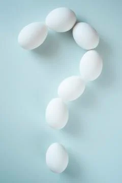 Question mark folded from white eggs Stock Photos