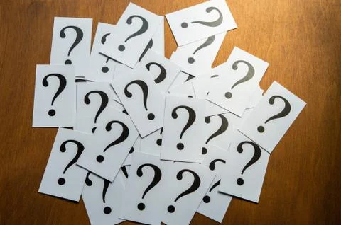 Question mark heap on table concept for confusion, question or solution Stock Photos