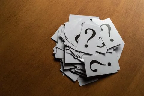 Question mark heap on table concept for confusion, question or solution Stock-Fotos