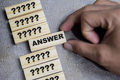 Question mark icon and selected answer on stacked wooden cubes on the table Stock Photos