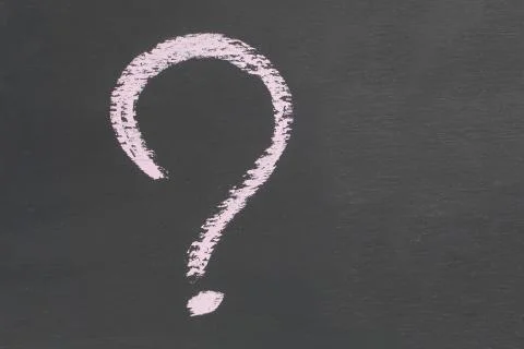 Question mark Icon drawn in chalk on a dark slate Copy space Stock Photos
