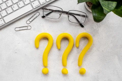 Question mark icon on office or students desk. Solving problem concept Stock Photos
