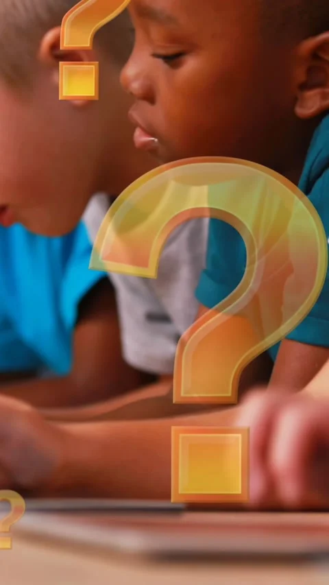 Question mark icons floating against group of kids using electronic devices at Stock Footage 342136339