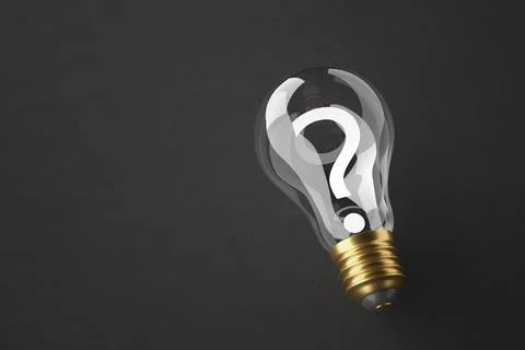 Question mark inside the light bulb on the gray table. The concept of finding Illustrazione stock