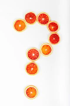 Question mark made from citrus fruit blood oranges on white background Stock Photos