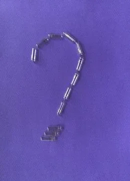 Question mark made of empty pill capsules on a lilac background. Stock Photos