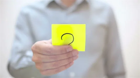 Question mark. A man sticks a note on transparent screen Stock Footage 68088686