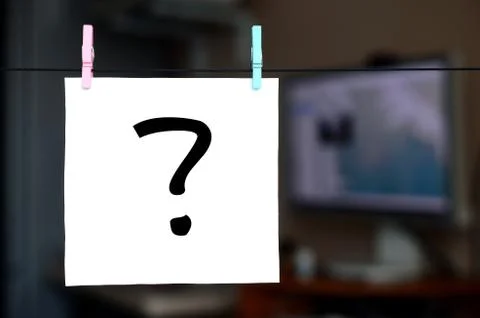 Question mark. Note is written on a white sticker that hangs with a clothespi Stock Photos