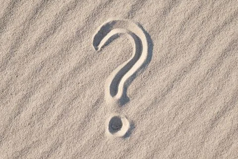 Question mark on sand beach Stock Photos