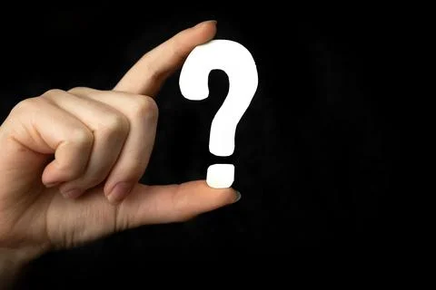 Question mark sign in hand. Question icon, symbol on a black background Stock Photos