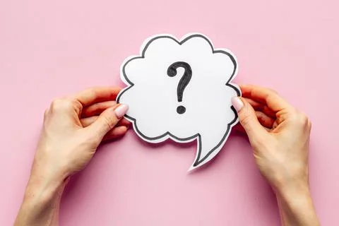 Question mark on speech bubble in hands. FAQ or search information Stock Photos