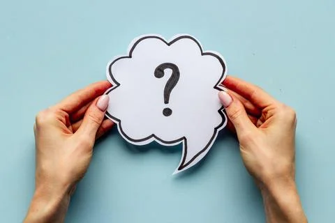 Question mark on speech bubble in hands. FAQ or search information Stock Photos