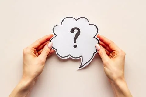 Question mark on speech bubble in hands. FAQ or search information Stock Photos