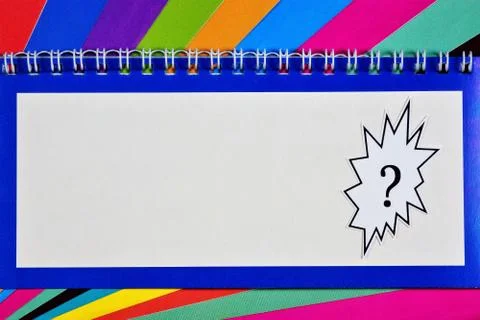Question mark of speech in the text frame of a writing pad Stock Photos