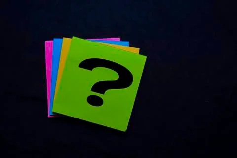 Question mark on sticky notes isolated on black background Stock Photos
