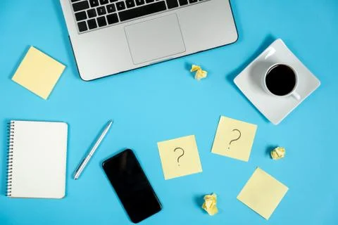 Question mark on sticky notes, notebook, laptop, cup coffee, phone Stock Photos