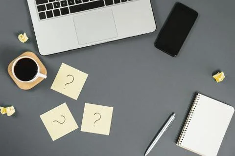 Question mark on sticky notes, notebook, cup coffee, phone Stock Photos