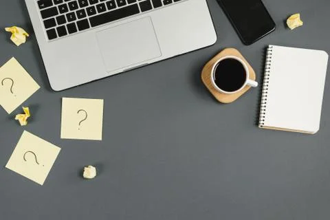 Question mark on sticky notes, notebook, cup coffee, phone Stock Photos