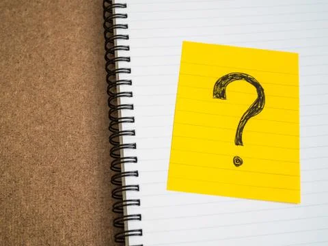 Question mark symbol on sticky note paper Stock Photos