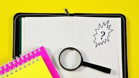 A question mark, a text inscription on a notepad. Stock Photos