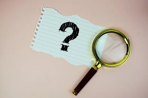 Question Mark text written on paper with magnifying glass flat lay on pink .. Stock Photos