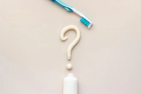 Question mark of toothpaste with toothbrush, top view. Oral care and hygiene Stock Photos