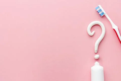 Question mark of toothpaste with toothbrush, top view. Oral care and hygiene Stock Photos