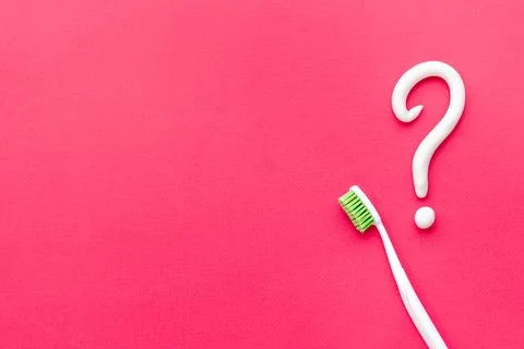 Question mark of toothpaste with toothbrush, top view. Oral care and hygiene Stock Photos