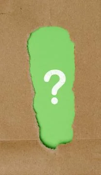 Question mark in a torn brown paper frame Stock Photos