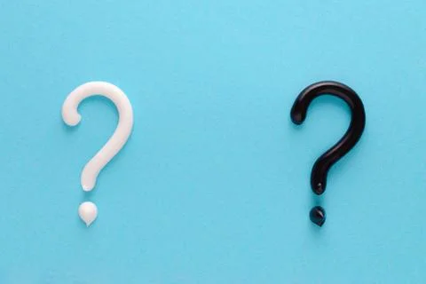 Question mark from white and black toothpaste on blue background Stock Photos