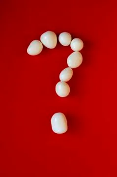 Question mark in a white small pebbles Stock Photos