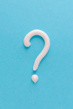 Question mark from white toothpaste on blue background Stock Photos